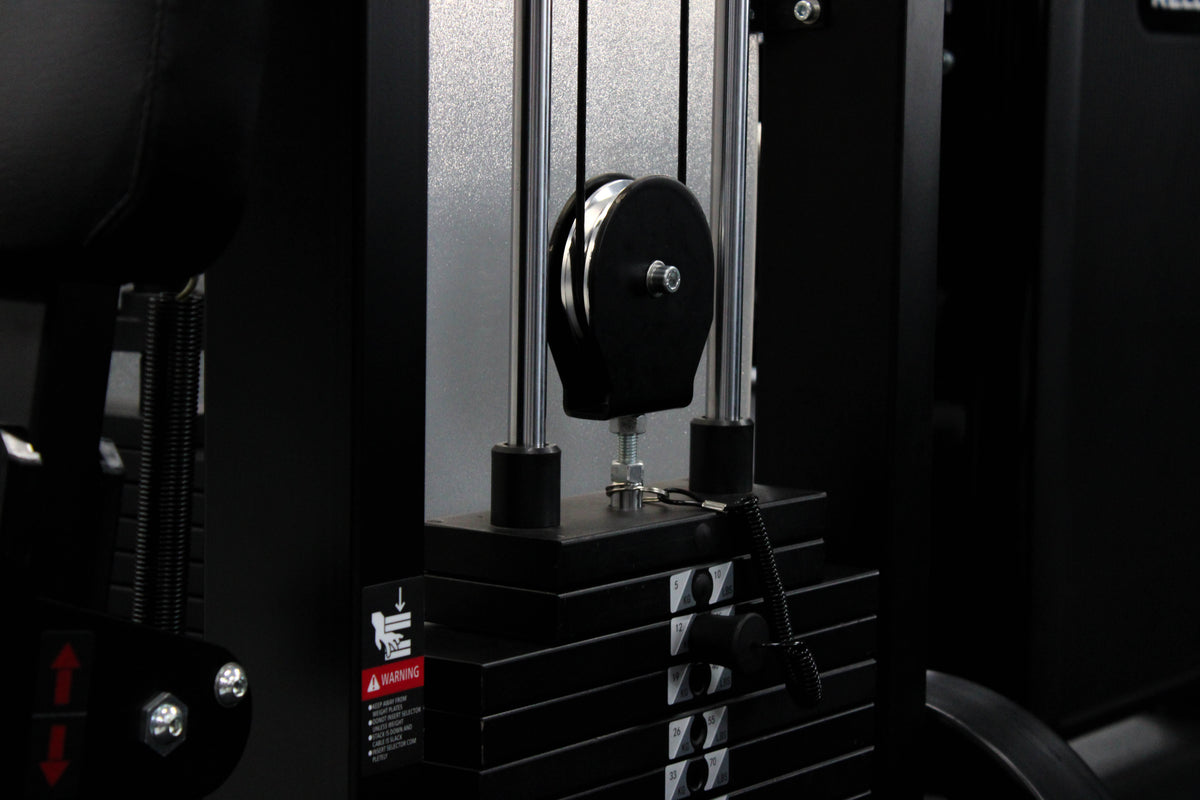 Reload Leg Curl machine - matte black frame red seat in commercial gym