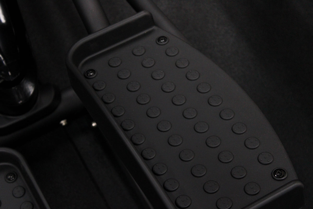 Close-up of a FLO STRIDE exercise bike with orange and black design.