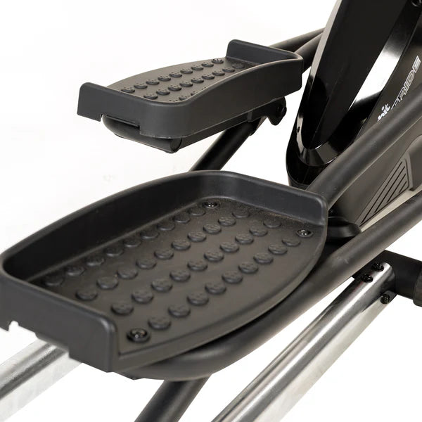 Close-up of a black exercise bike pedal with textured surface on a white background