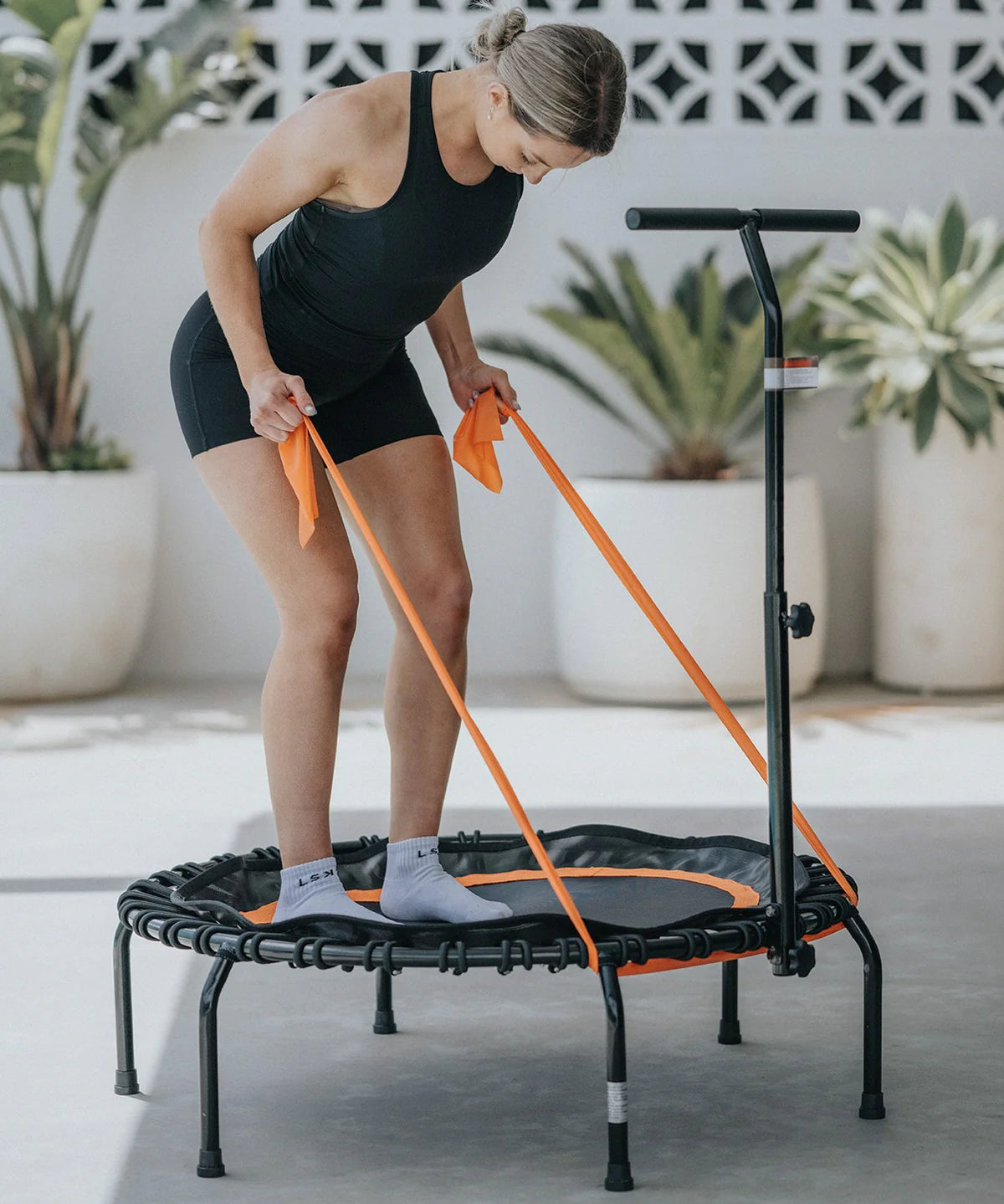Orbit Rebounder Trampoline Package - Lightweight. Girl working out on it