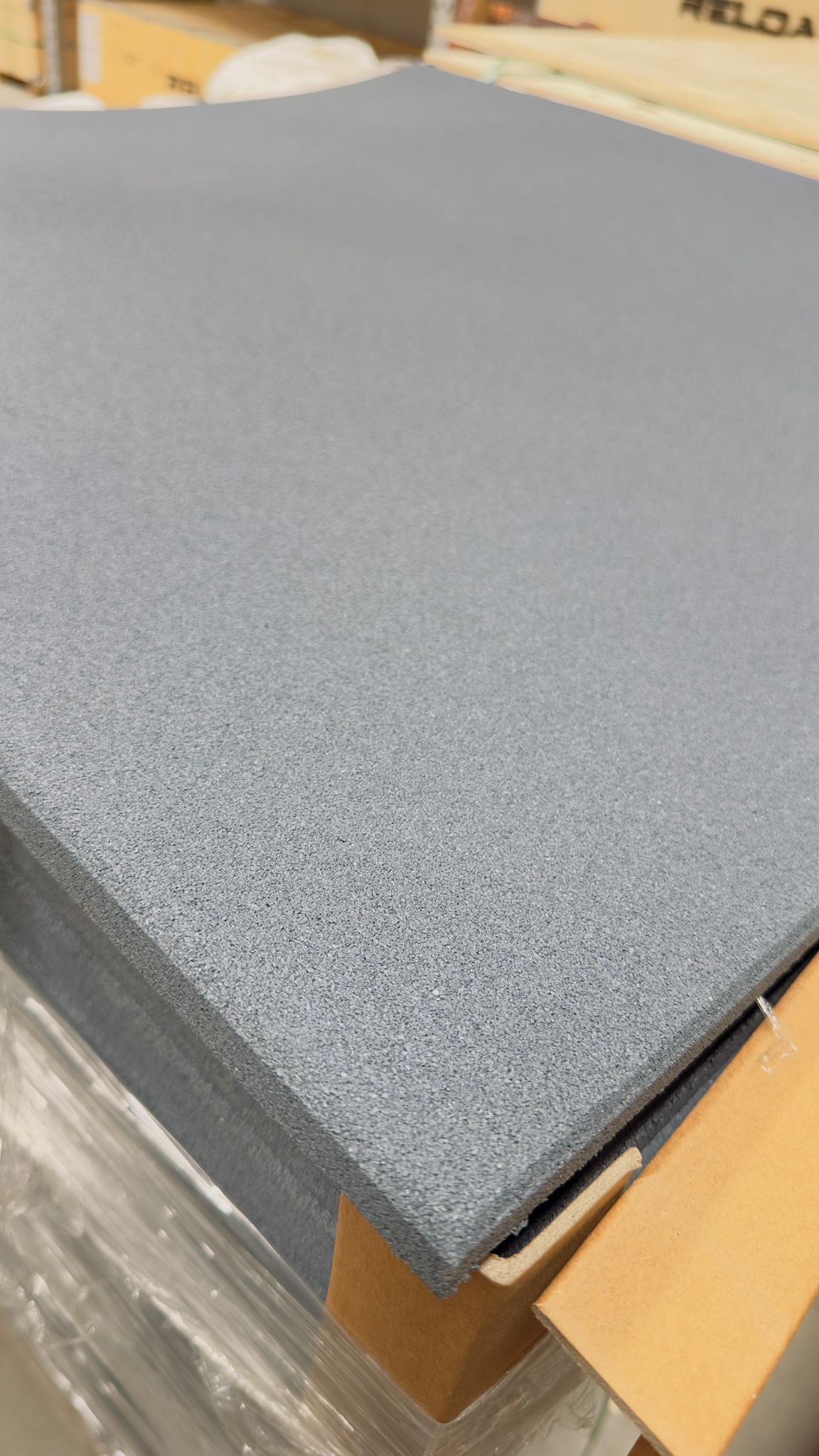 A close-up of a grey commercial gym flooring tile 15mm thick