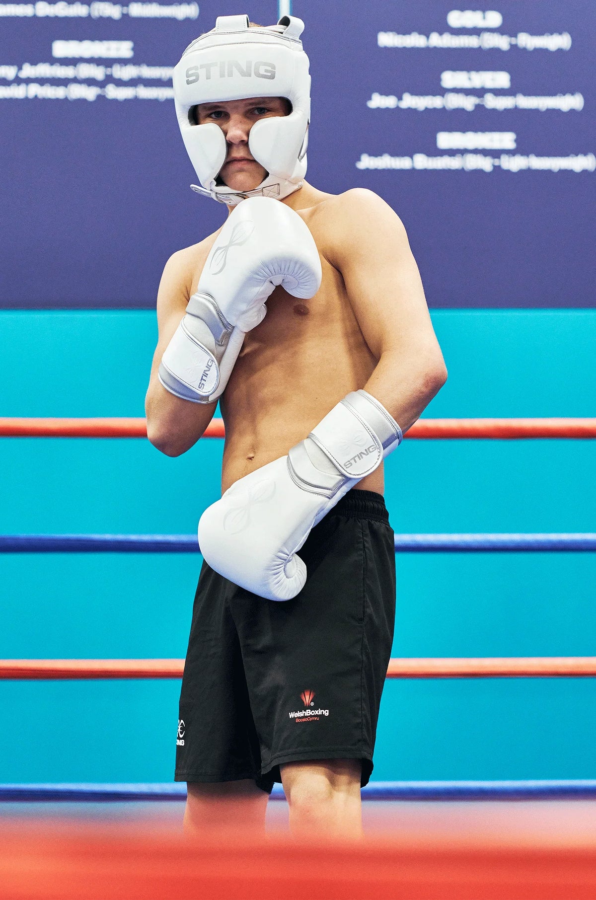Boxer in a boxing ring wearing sting headgear and gloves