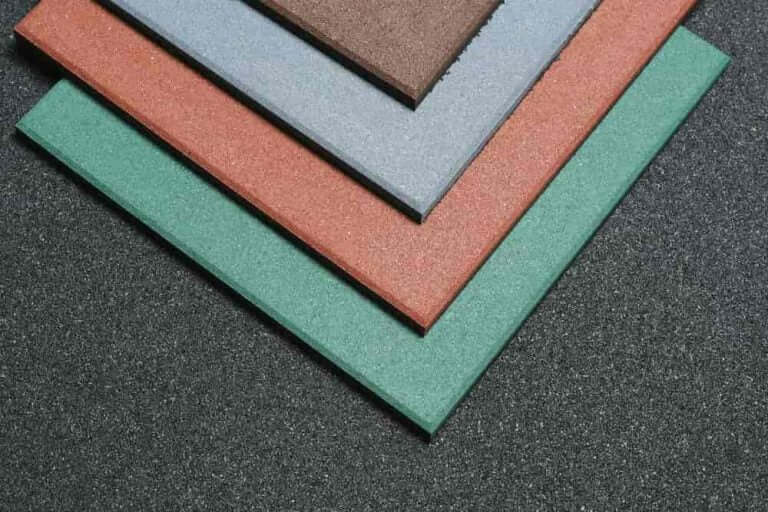 Color swatches of different shades on a textured gym flooring surface