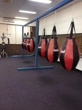 Setup of the punch bag in a boxing studio. Training facillity