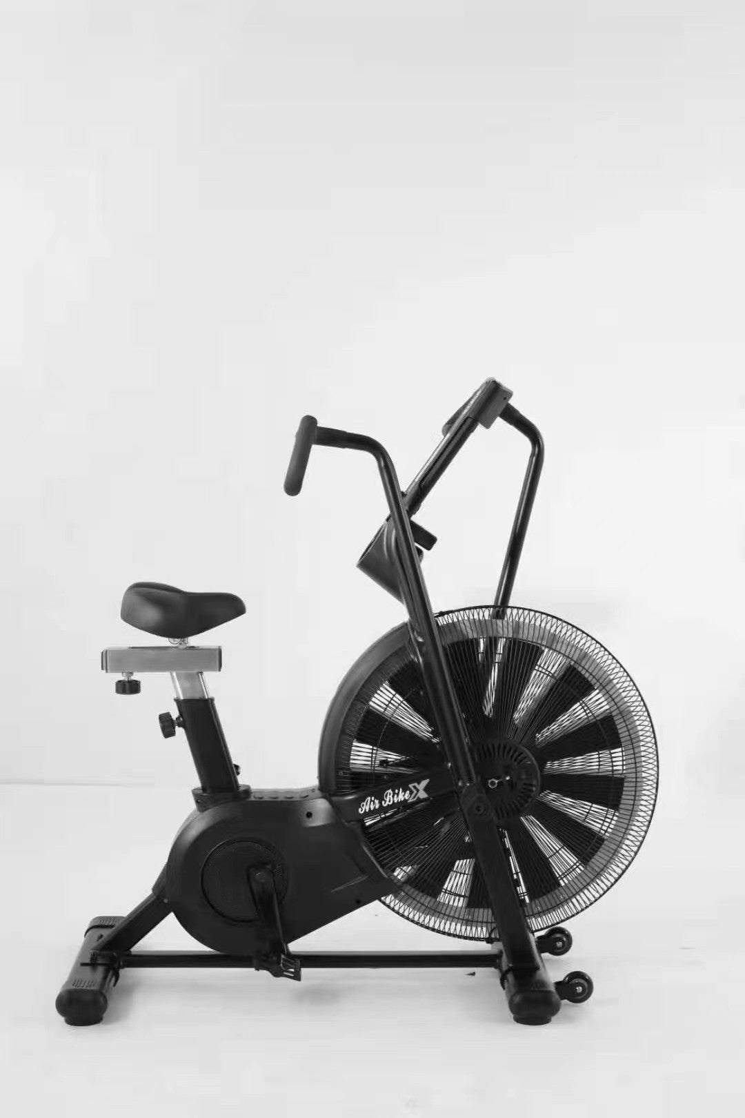 Black exercise bike with fan on a white background
