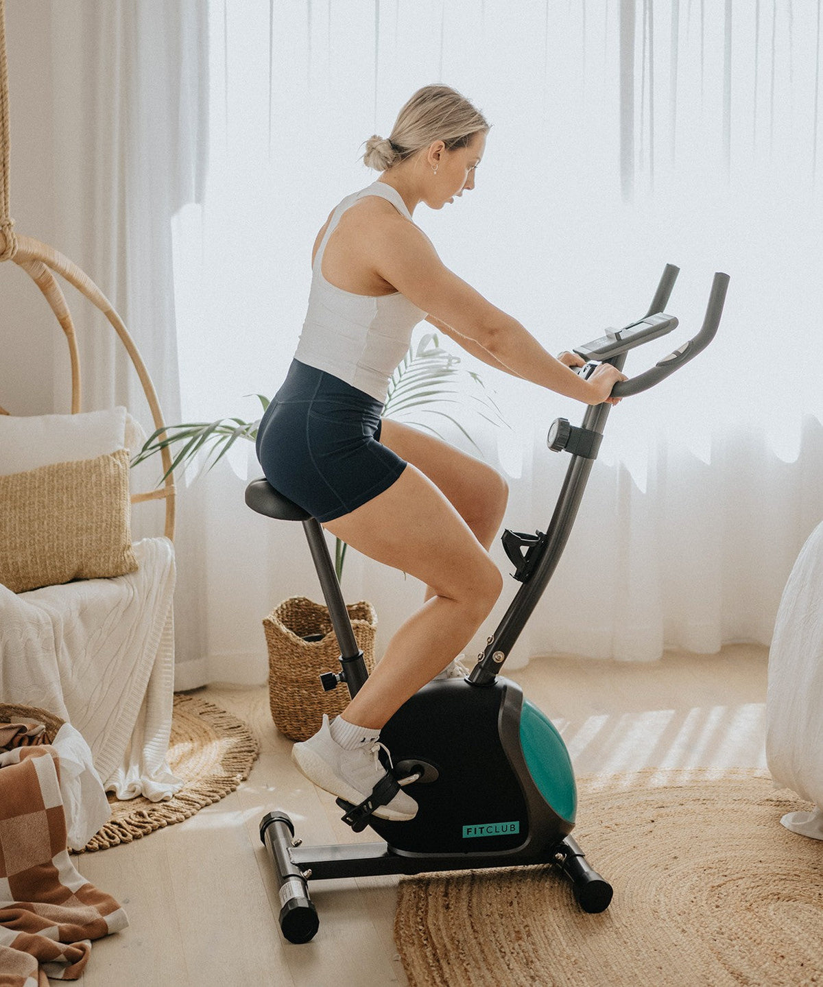 Side view of the compact FitClub Exercise Bike in a home setting