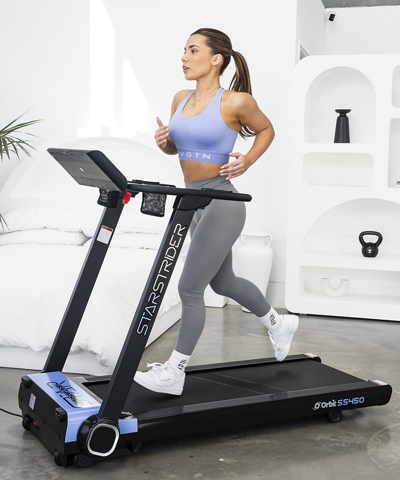 Shock absorption treadmill deck on the StarStrider SS450 for joint-friendly workouts. Girl working out at home