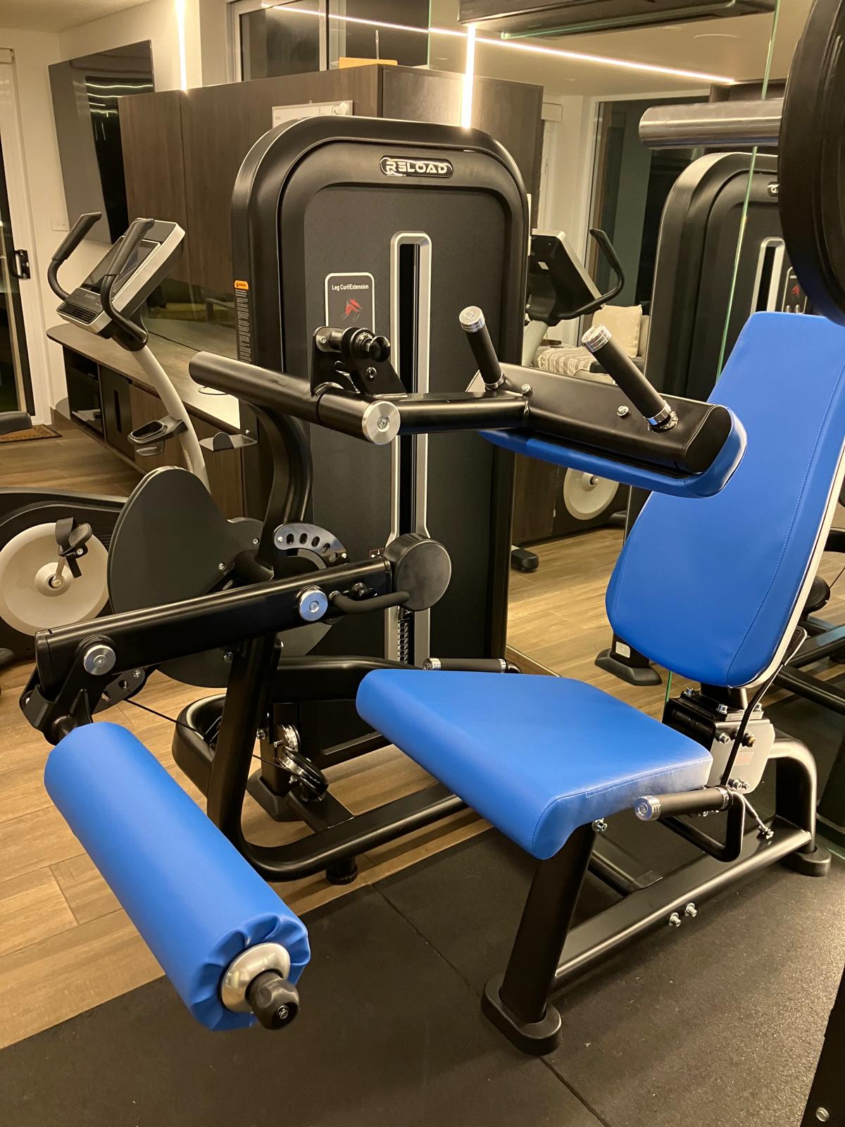 Dual Leg Curl / Leg Extension Pin Loaded Machine [T-MAX Series] with blue seat black frame front view