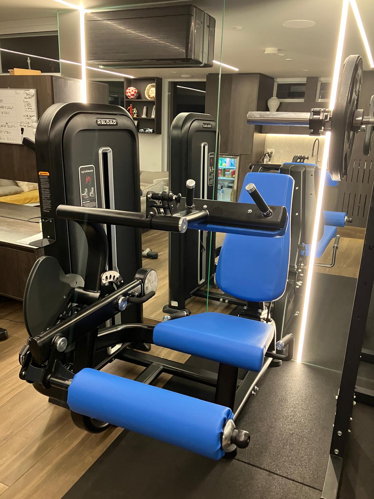 Dual Leg Curl / Leg Extension Pin Loaded Machine [T-MAX Series] with blue seat black frame front view