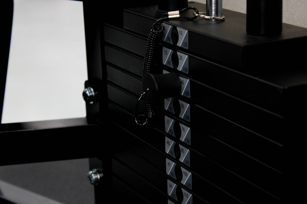 Reload Leg Curl machine - matte black frame red seat in commercial gym