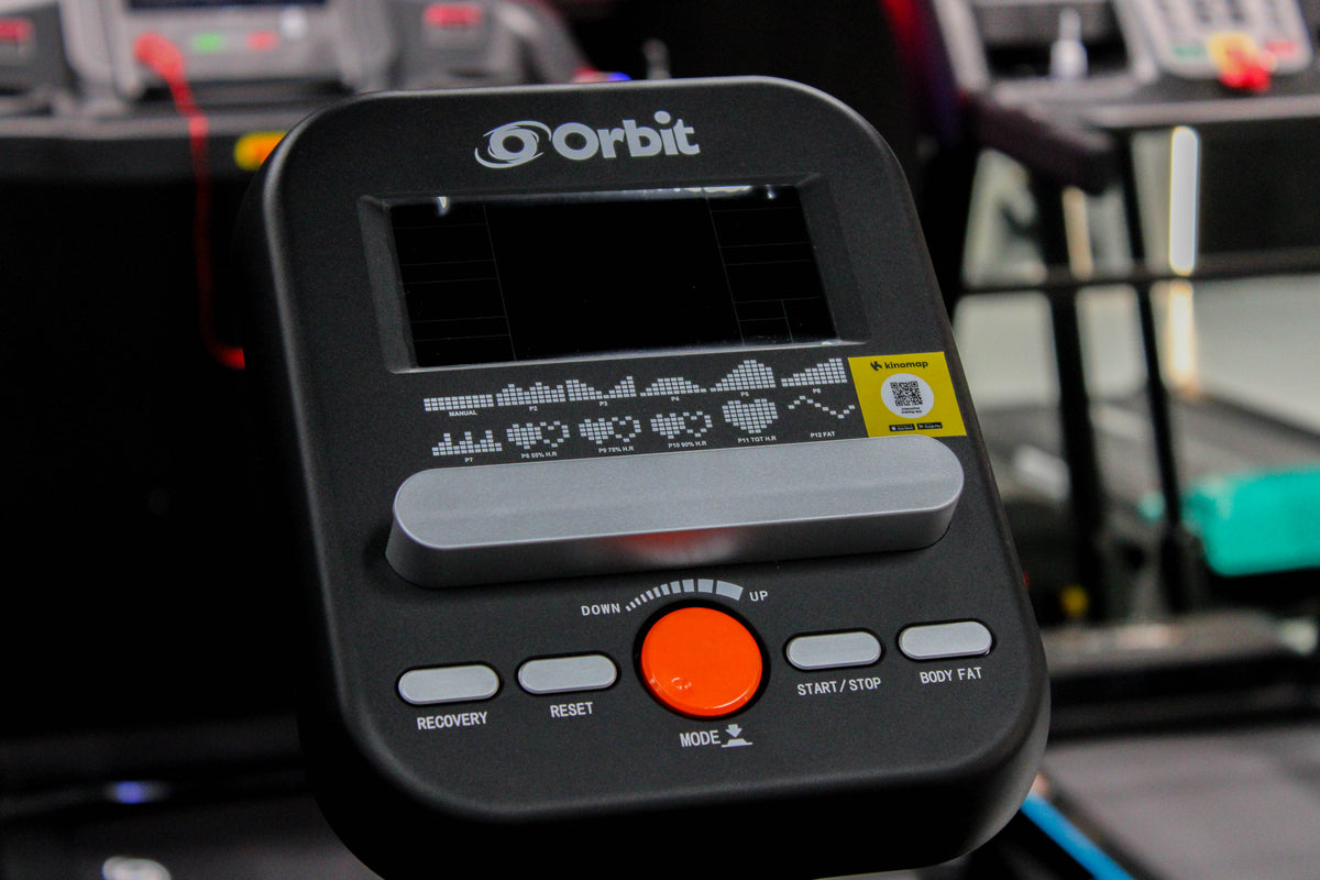 Close-up of a FLO STRIDE exercise bike with orange and black design.