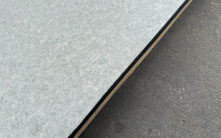 Edge detail of stone look PVC laminated gym flooring tile with rubber backing