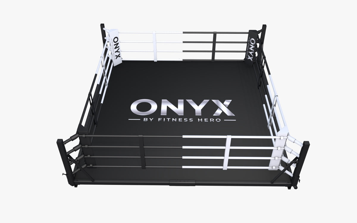 A boxing ring with a black mat featuring the 'ONYX BY FITNESS HERO' logo available in 4 + 5m ring
with or without flooring