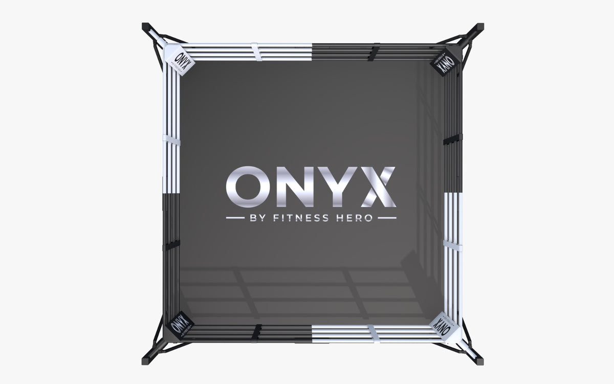 A boxing ring with a black mat featuring the 'ONYX BY FITNESS HERO' logo available in 4 + 5m ring
with or without flooring