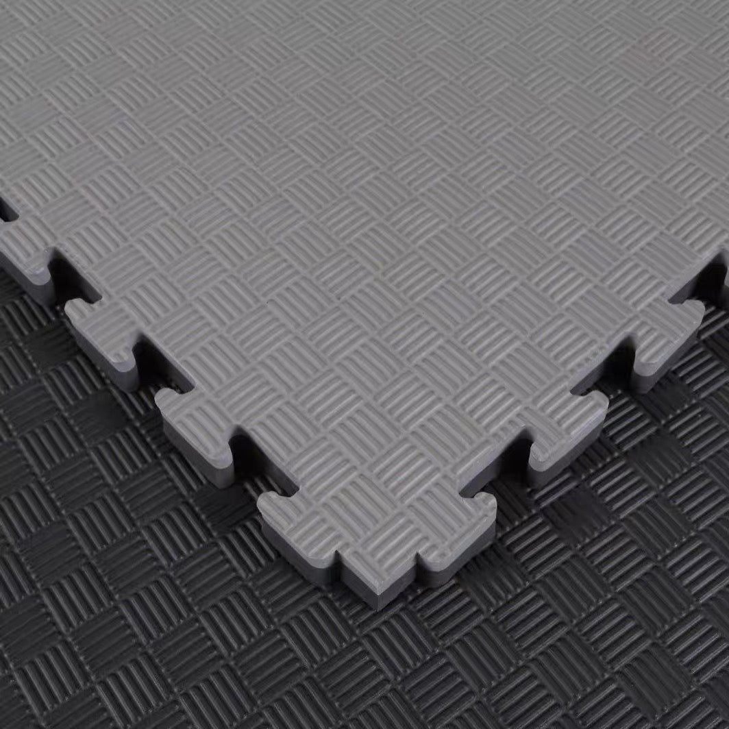 Close-up of ONYX T-Pattern EVA surface - ribbed checker weave texture, grey tile over black