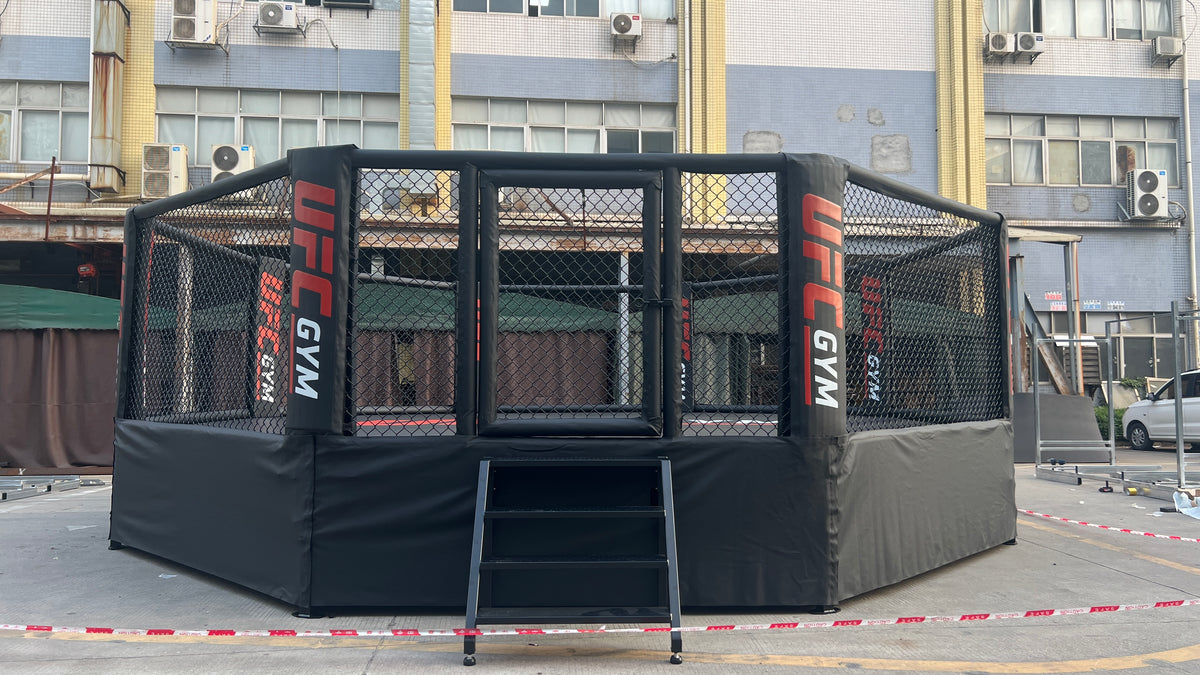 MMA fighting cage with UFC Gym branding in an urban setting