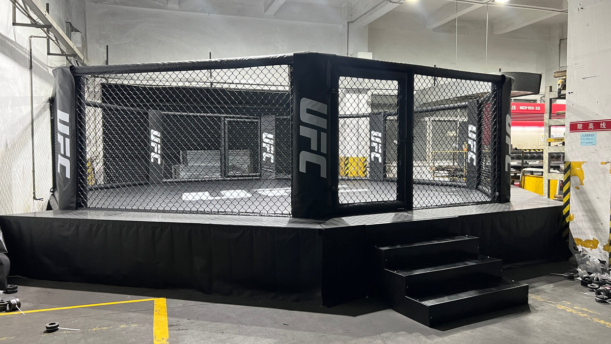 Side view of elevated MMA cage with mesh walls, floor mats and T‑Flex cov