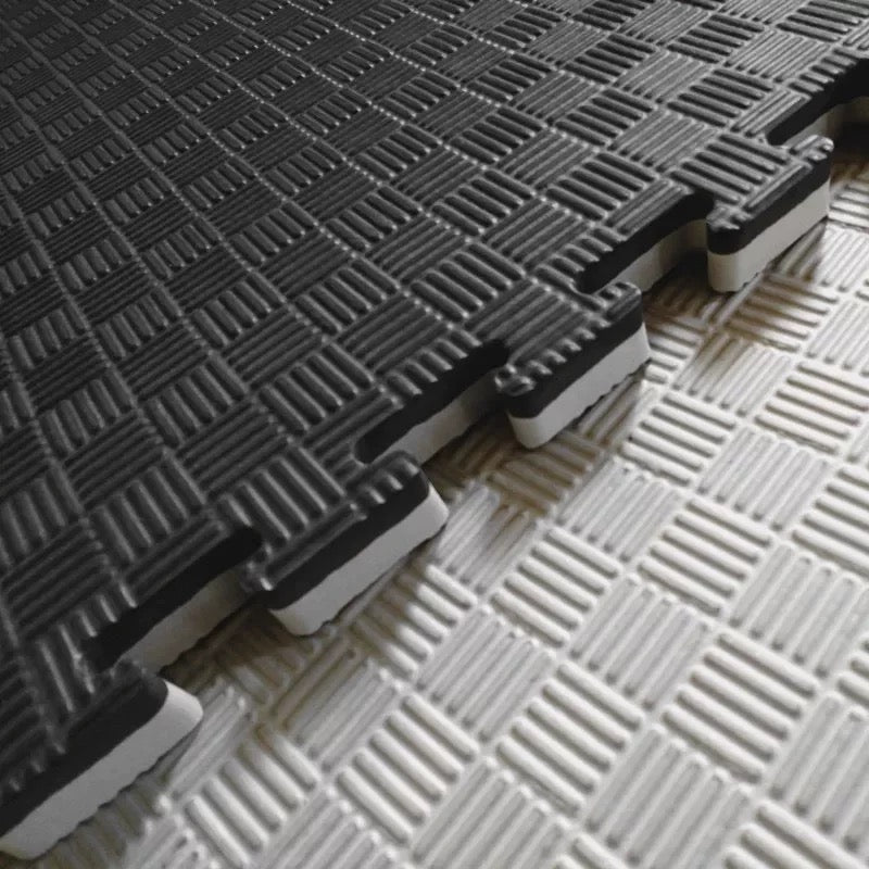 Gray interlocking foam mats on a white background