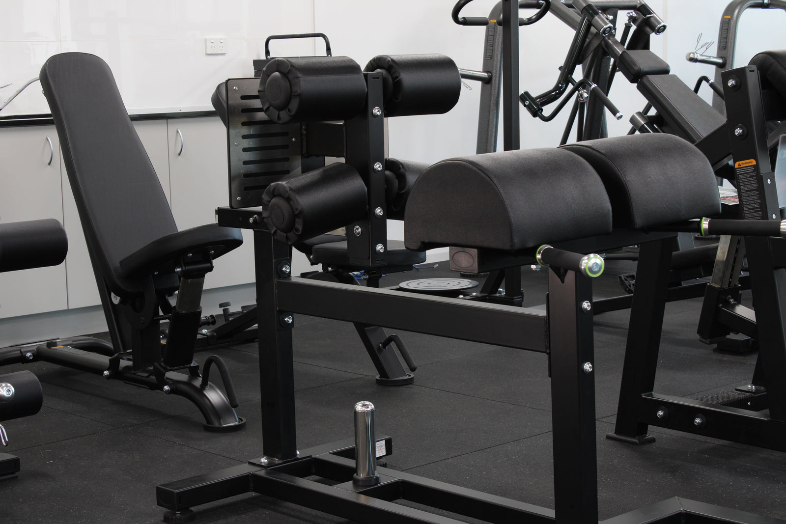 Dominator Glute Ham Developer GHD Machine - commercial grade black steel frame with adjustable ankle rollers and dual hip pads