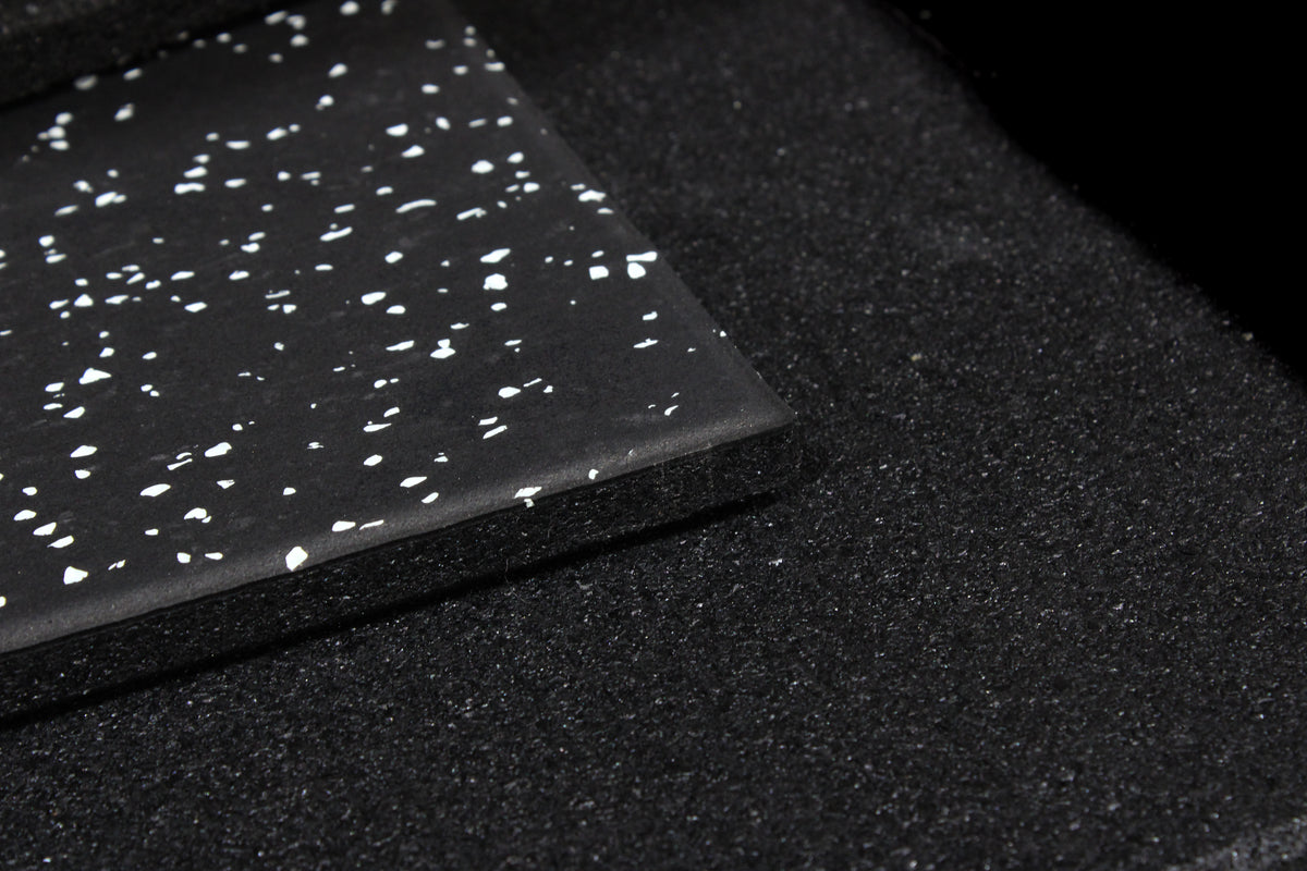 Black tile with grey speckles on a white background