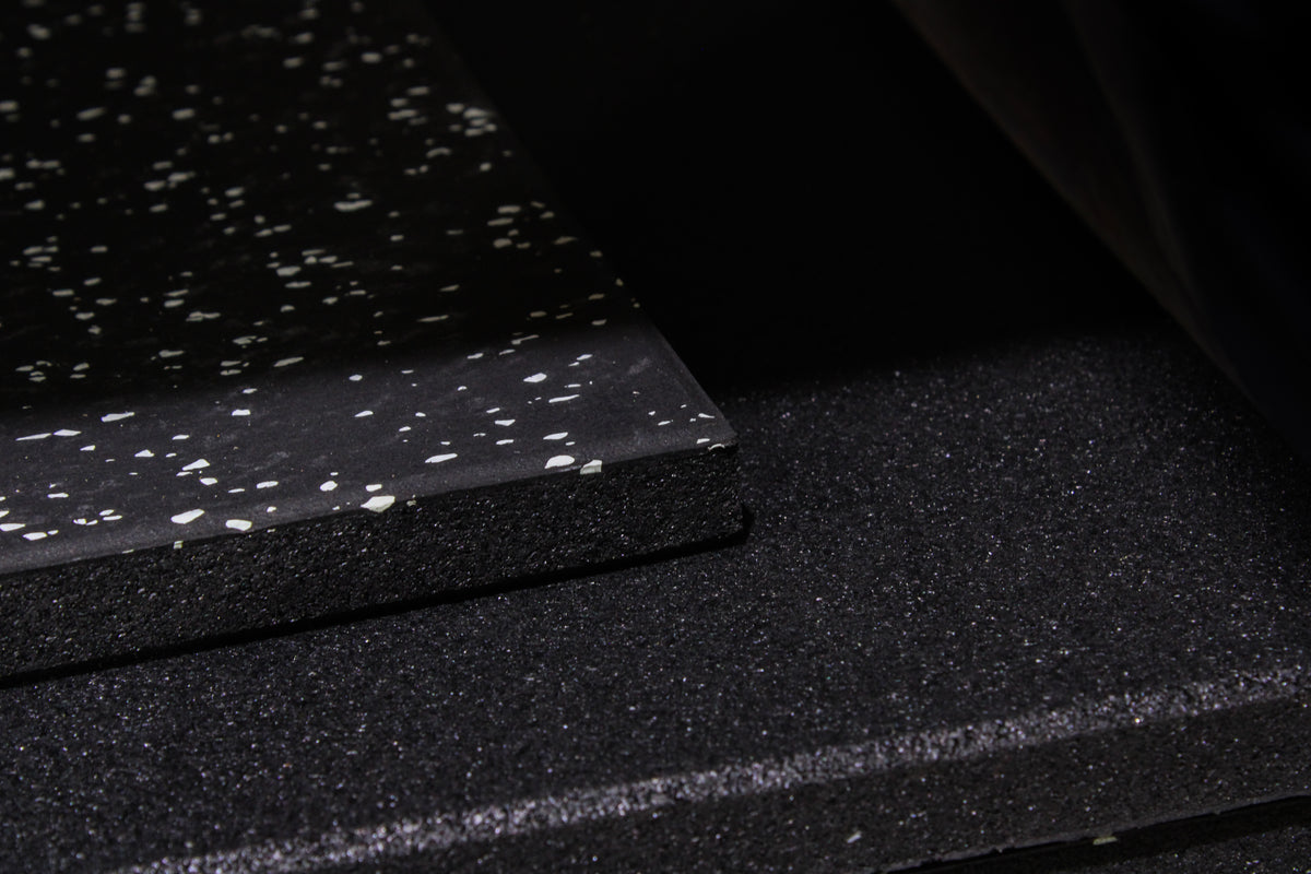 Black tile with grey speckles on a white background