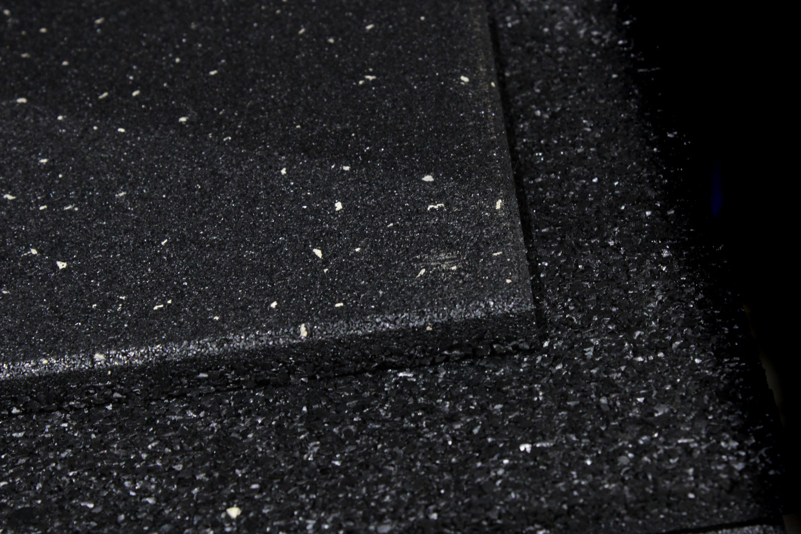 Black rubber mat with a speckled pattern on a white background