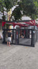Inside view of MMA cage showing monkey bars and multiple heavy bags suspended from pulleys on video