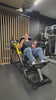 Plate Loaded Hack Squat Machine [Solaris Series] being used by a customer at a local gym